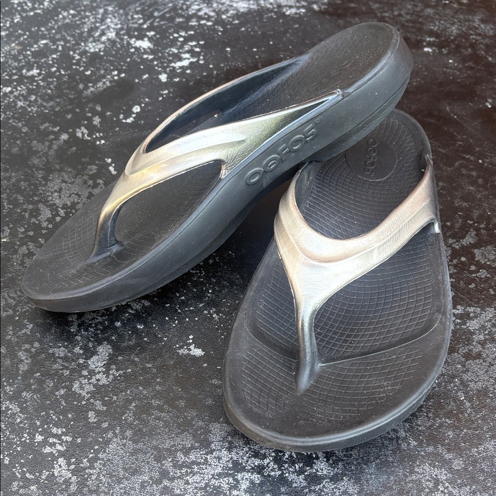 OOFOS Women's Black Flip Flop Sandals with Metallic Silver Straps